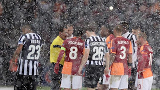 Galatasaray and Juventus players stand on the pitch as their Champions