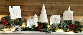 Vintage, Paint and more... Dollar Store village painted white on a snow themed mantel with pops of red color