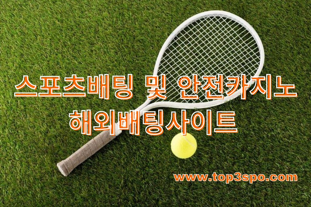 Top view of tennis racket and ball on green grass