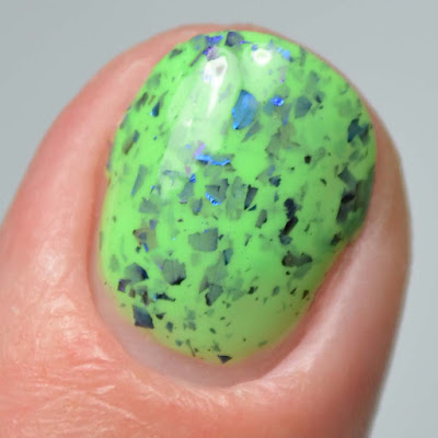 green nail polish with multichrome flakies close up