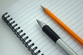 lined notepaper and pen and pencil 