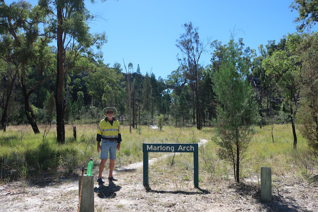 Al standing beside sign for Marlong Arch