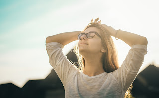 image of woman holding her head