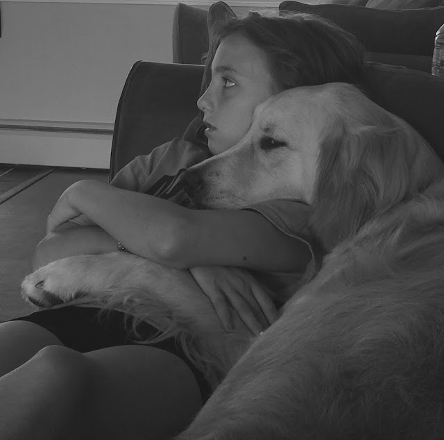 Dog laying on couch with human Sister Black and White Sunday Family Time