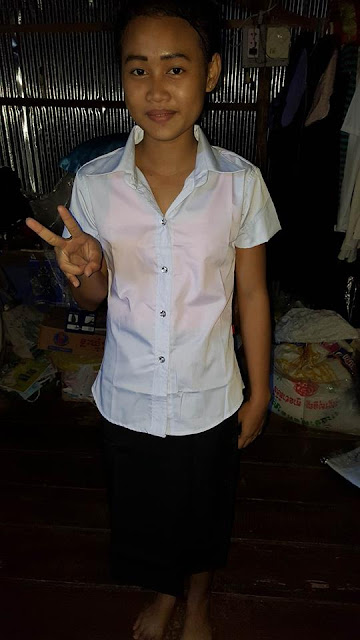 Srey Nett try her new school uniform