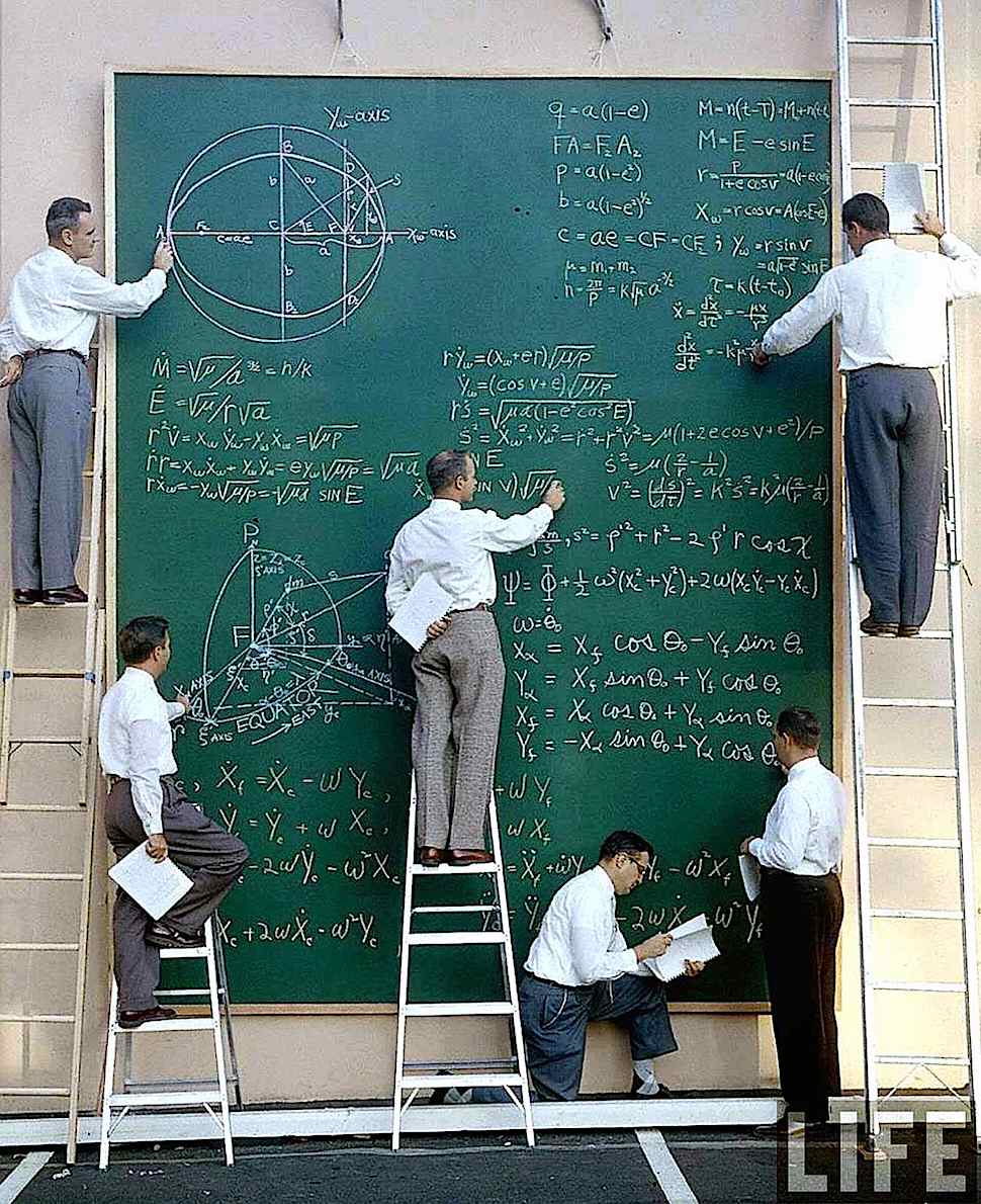 a photograph of scientists working on equations at a giant chalk board