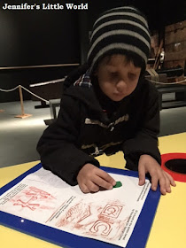 Child doing brass rubbings