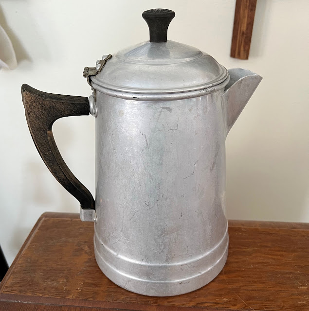 Photo of an old aluminum coffeepot.