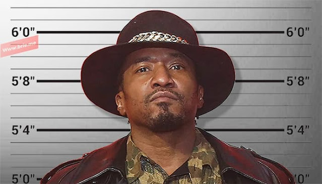 Q-Tip posing in front of a height chart background