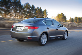 Rear 3/4 view of 2013 Acura ILX driving on mountain road