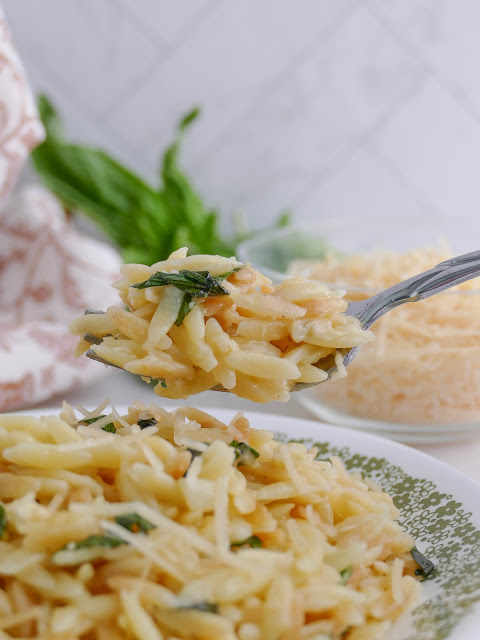 Parmesan Orzo scooped on a fork.
