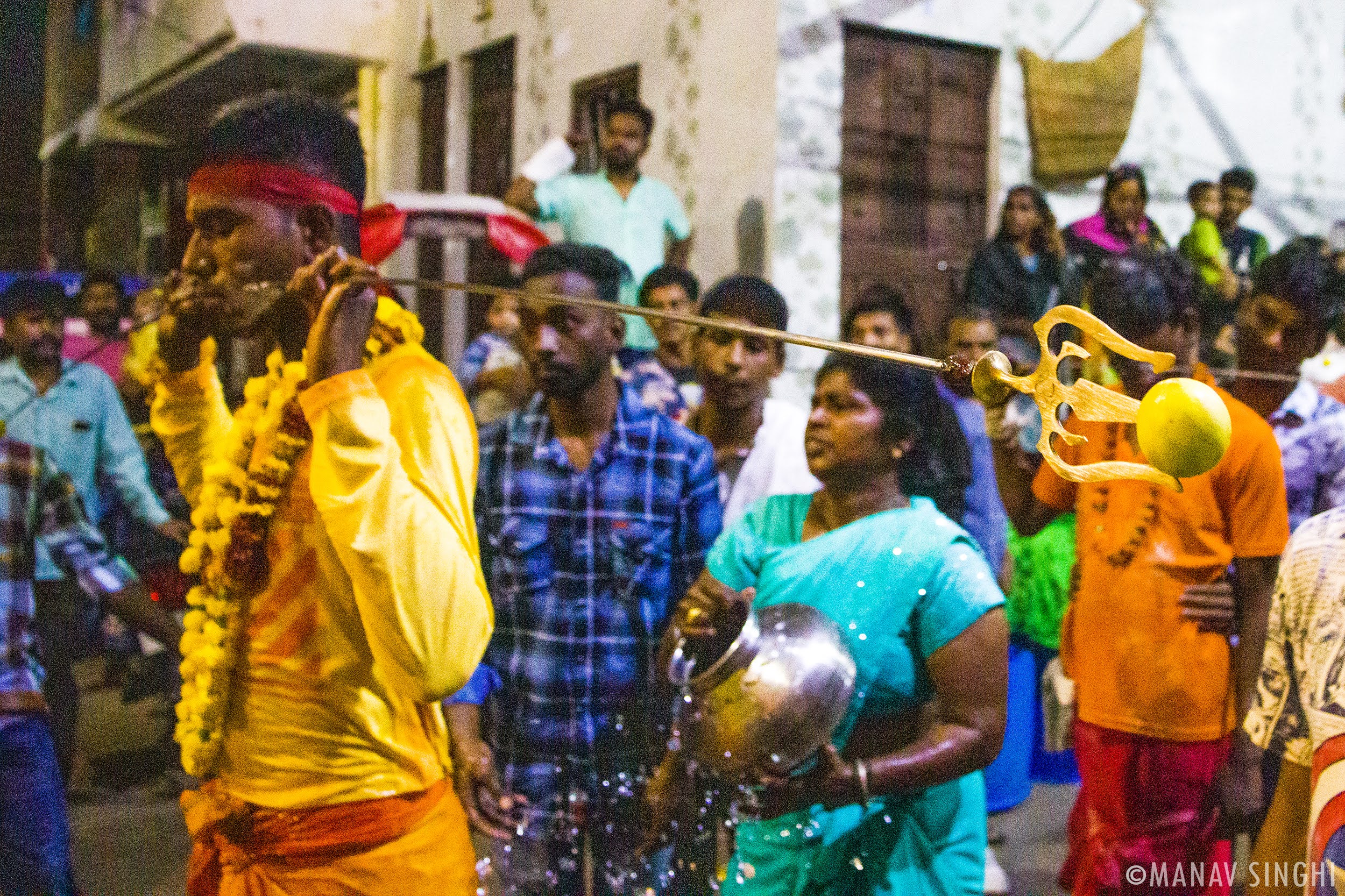 Tamil Hindu devotees cheeks pierced metal rods Sheetla Mata Maha Mariamman fire walking