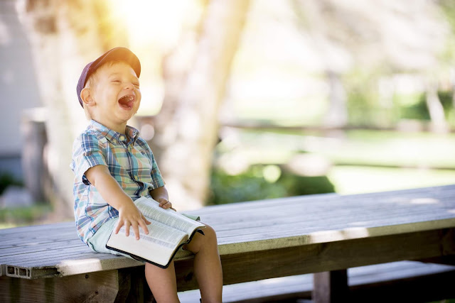 laughing child while reading