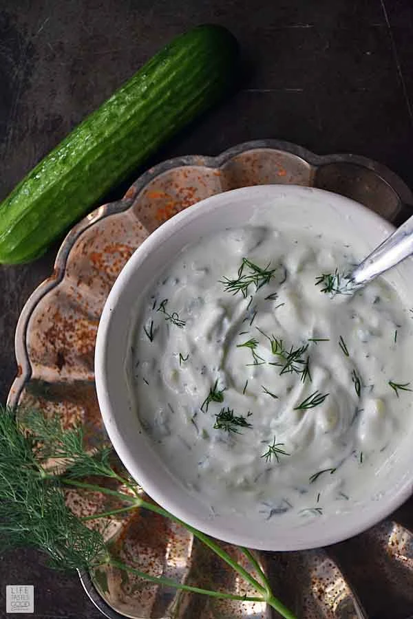 Tzatziki sauce in a white serving bowl garnished with fresh dill ready to serve with my Greek Bowl recipe