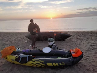 Sunrise over the sea, our two boats on a beach
