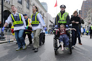 One of them, which you have to click on separately, clearly shows a man who . (boston marathon victims being wheeled away )