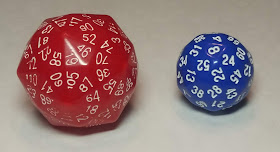 A large red die with so many faces it's little more than a sphere with a few pointy areas, with white numbers printed in a circle around each point, and a slightly smaller blue die with a series of white number on each face, which are diamond-shaped.
