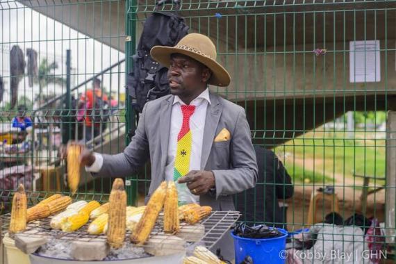 Check out this stylish man who sells roasted corn decked in suit and hat (photos) 