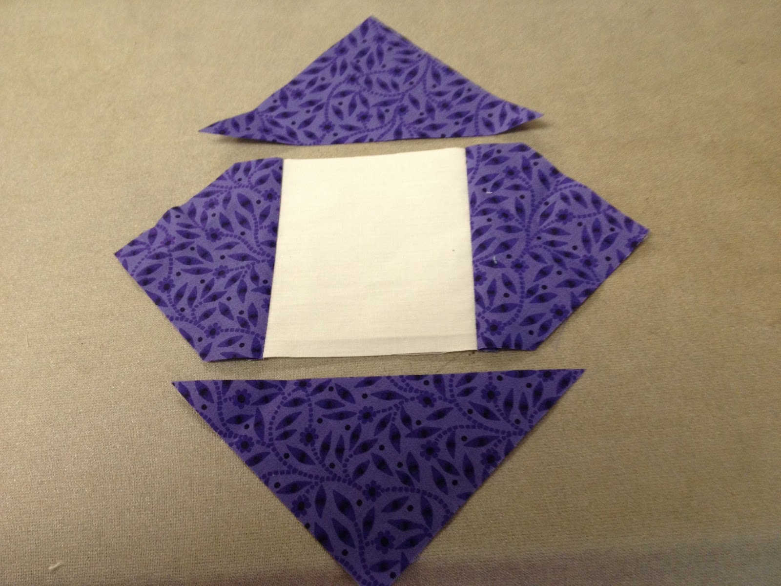 Sew on the 2 remaining color triangles, press away from center.﻿