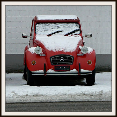 Snow on a red Deux Chevaux