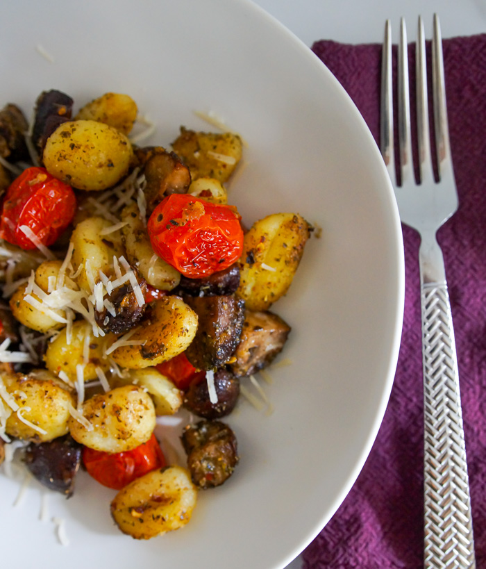 Trader Joe's Chicken Meatballs and Gnocchi Sheet Pan Dinner in shallow bowl with purple napkin and fork