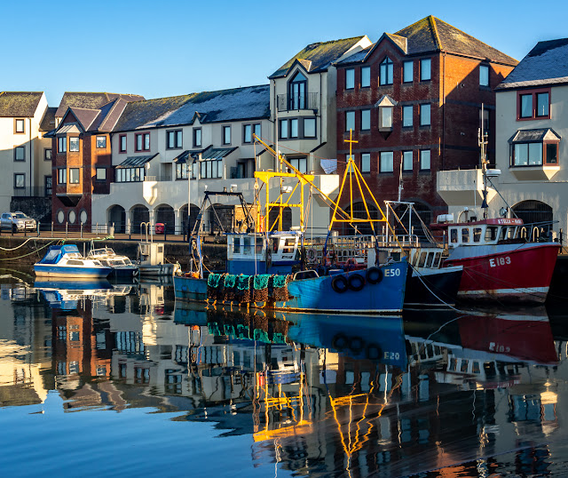 Photo of near perfect reflections in the still water in the harbour