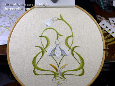 Crewel embroidery of snowdrops in progress. Ready to add trellises to flower tops and bulb at the bottom.