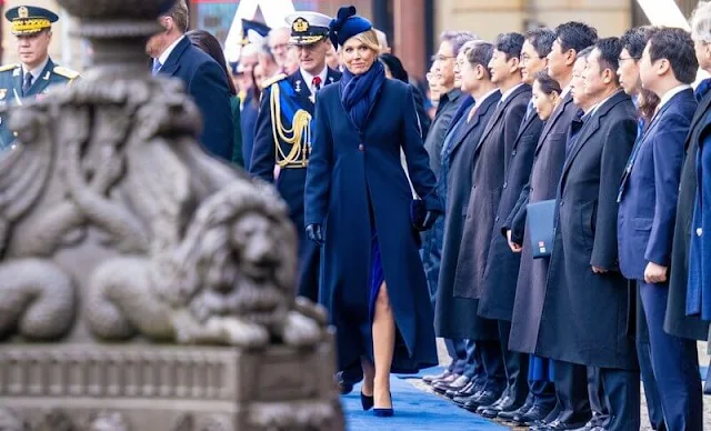 Queen Maxima wore a navy blue wool coat and, blue silk dress by Natan. Kim Keon Hee wore a green wool coat by Max Mara