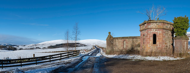 Balintore castle gate and the road back down the glen in snow