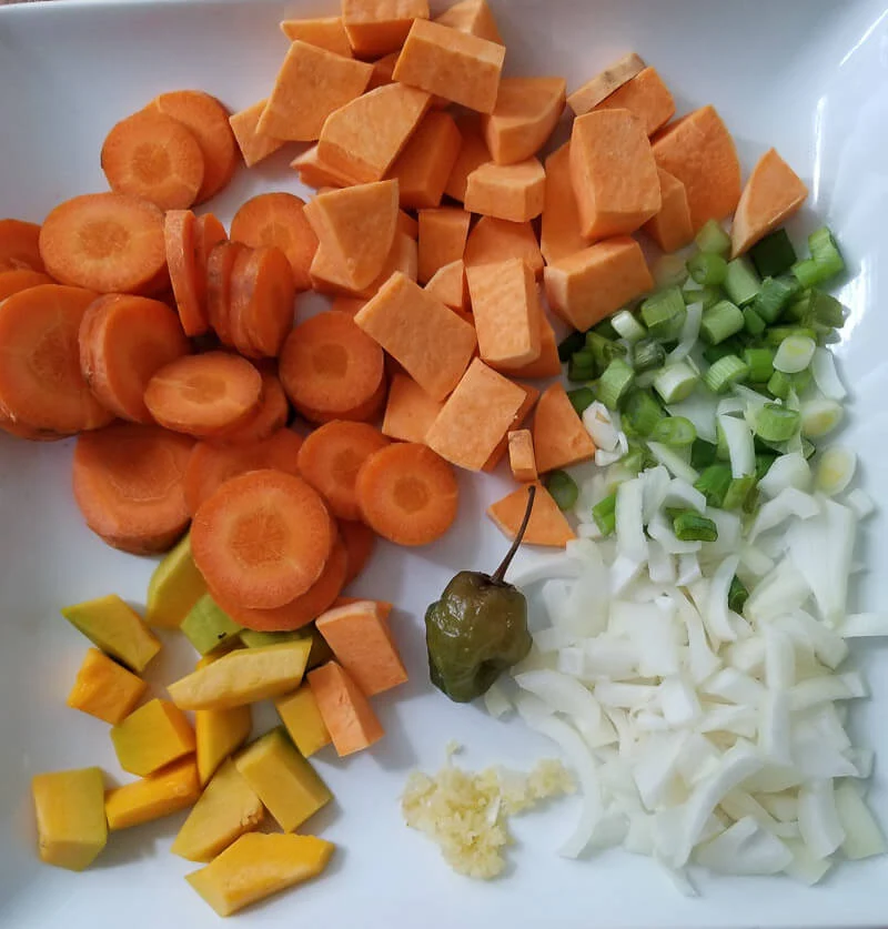 Ingredients to be used for the soup on a white plate