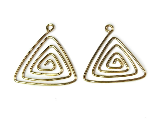 Two wire spiral triangles, approximately the same shape and size.