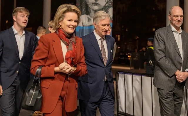 Queen Mathilde wore an orange brown two-button blazer suit jacket by Dries Van Noten. Les Miserables novel by Victor Hugo