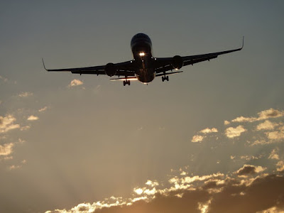 Boeing plane flying in bright clouds