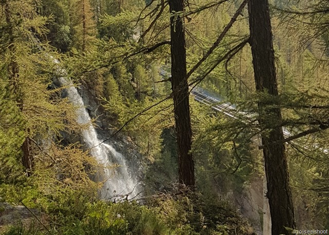 Hike from Sunnegga to Zermatt along Gourmetweg. A waterfall just above the tracks of the Gornergrat Bahn railway.