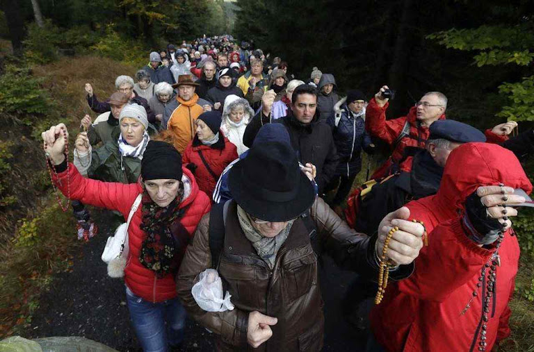 Poloneses rezam caminhando na floresta de Szklarska Poreba, fronteira com a Republica Checa