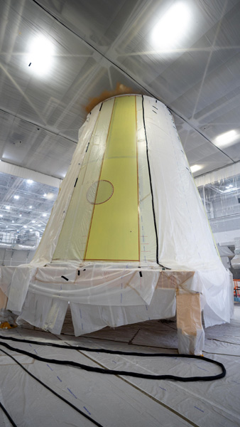 At NASA's Marshall Space Flight Center in Huntsville, Alabama, the first round of spray-on foam is applied to the launch vehicle stage adapter for the Space Launch System rocket that will fly on Artemis 3.