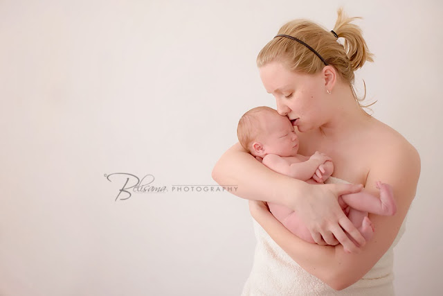 newborn baby boy with mother in front of white background