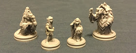 the four miniatures from the game, modelled in simple grey plastic.