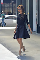 Victoria Beckham leggy in a short blaack dress