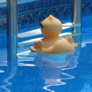 Ducky by the pool ladder.