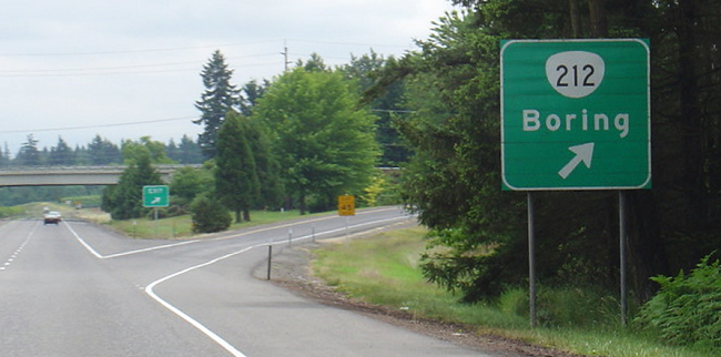 A motorway exit sign pointing to a town called Boring