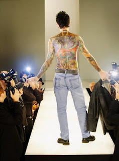 Colorful back tattoo designs on the body of a man