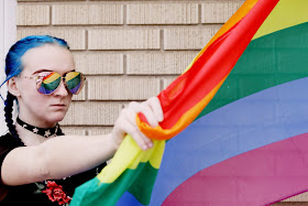 woman holding a rainbow pride flag