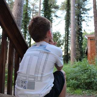 Autistic boy sitting on a step and thinking