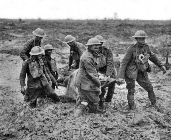 Stretcher bearers struggle through deep mud carrying a wounded soldier at Passchendaele, August 1917.
