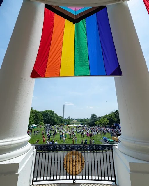 America LGBTQ flag and American flag together in Whitehouse