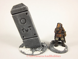 Tall stone pillar 25-28mm scale scenery piece with Frostgrave explorer - front view.