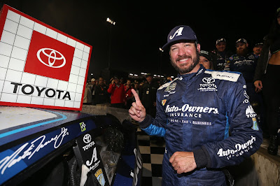   Martin Truex Jr, Driver of the #19 Auto Owners Insurance Toyota, Poses with  the Winners Sticker after the Monster Energy #NASCAR Cup Series Toyota Owners 400