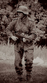 Waffen-SS Stormtrooper with MP 40 in combat.