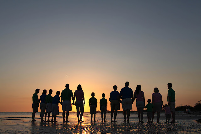 photograph of family walking on the beach near sanibel